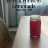 A picture of the herbal hibiscus lemonade in a mason jar on a table.